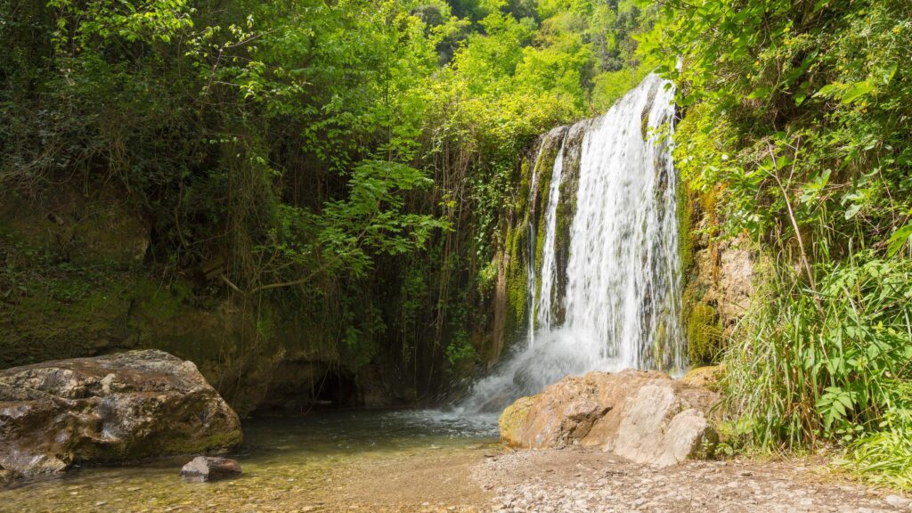 Waterfall surrounded by vegetation in Valle delle Ferriere near Amalfi